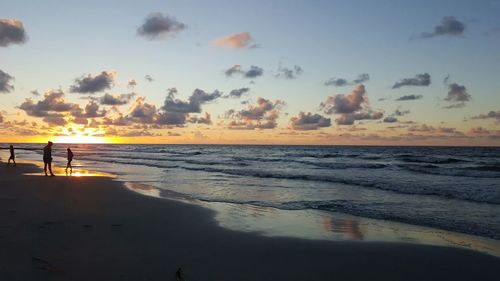 Scenic view of beach against sky during sunset