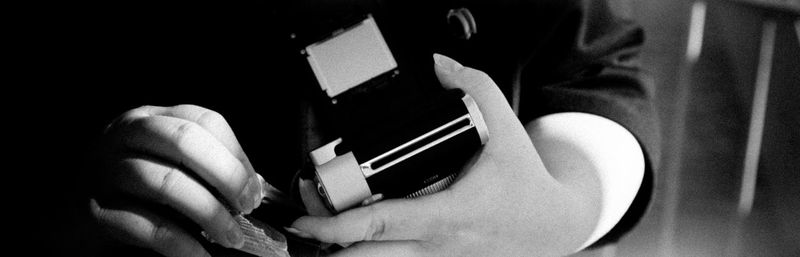 Close-up of a hand holding camera