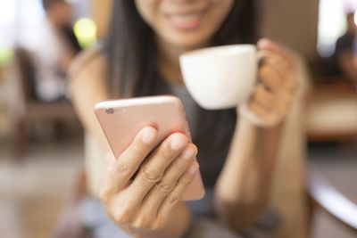 Close-up of woman holding smart phone