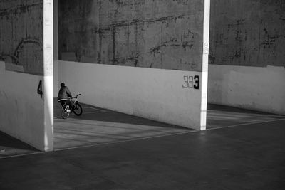 Bicycle parked by wall in building