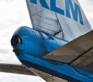 Low angle view of airplane against cloudy sky