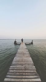 Pier over sea against clear sky