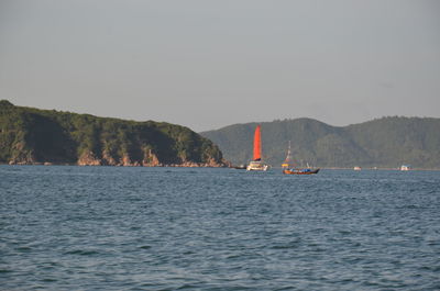 Sailboat on sea against clear sky