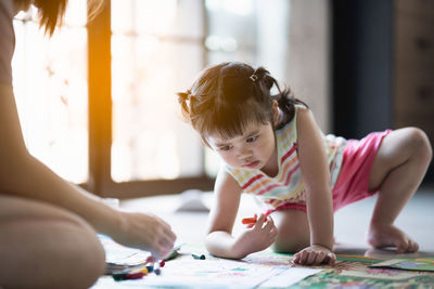 Cute girl drawing at home