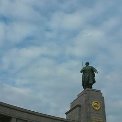 Low angle view of statue against cloudy sky