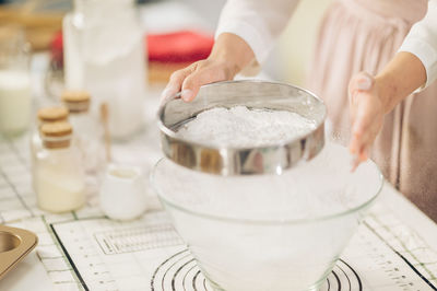 Midsection of man preparing food in kitchen