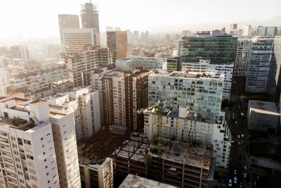 High angle view of buildings in city against sky