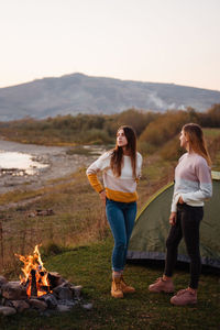 Rear view of woman standing on mountain