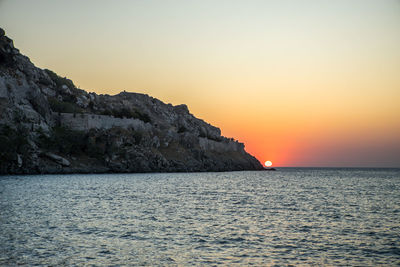 Scenic view of sea against clear sky during sunset