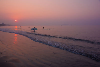 Scenic view of beach against sky during sunset