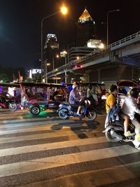 People riding motorcycle on road at night