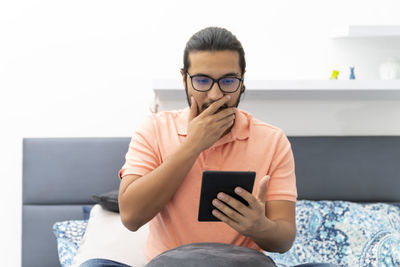 Midsection of man using mobile phone