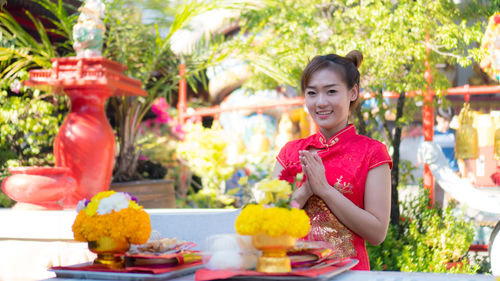 Portrait of smiling young woman standing outdoors