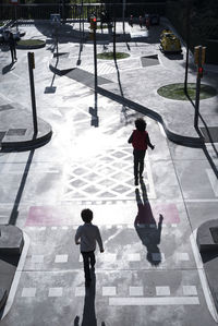 High angle view of children walking on footpath