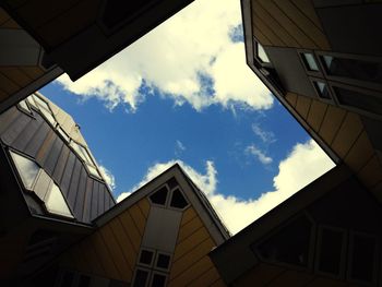 Low angle view of building against cloudy sky