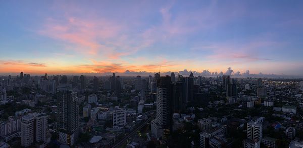 High angle view of modern buildings against sky during sunset