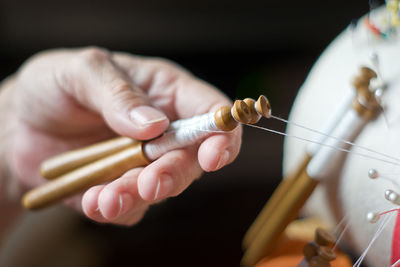 Close-up of person holding sewing items