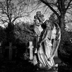 Men statue against trees