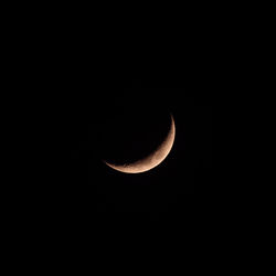 Low angle view of half moon against sky at night