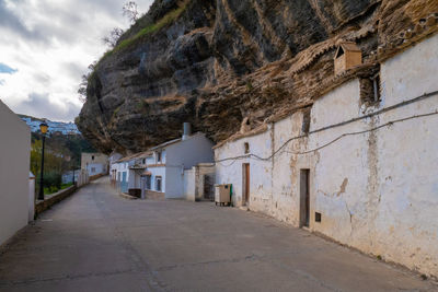 Empty road amidst buildings in town