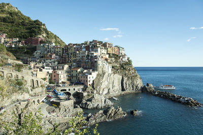 Panoramic view of sea and buildings against sky