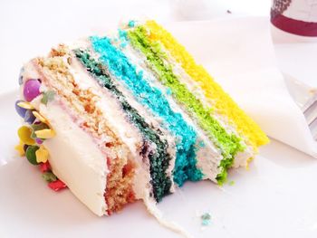 Close-up of colorful cake slice on table