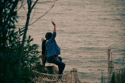 Rear view of woman standing in sea