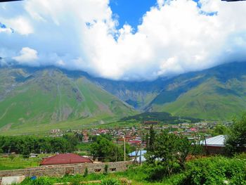 Scenic view of mountains against cloudy sky