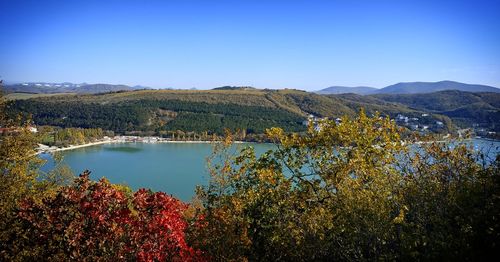 Scenic view of lake against clear blue sky