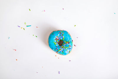 High angle view of multi colored candies on white background