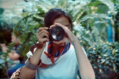 Portrait of woman photographing 