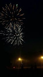 Low angle view of firework display at night