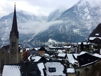 Townscape against mountain during winter