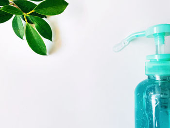 Close-up of glass bottle against white background