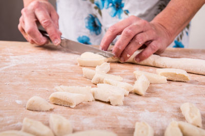 Midsection of man preparing food on table