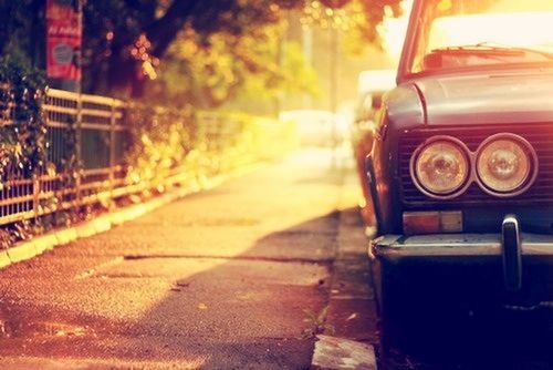 land vehicle, car, transportation, mode of transport, street, old-fashioned, outdoors, close-up, focus on foreground, sunlight, retro styled, no people, day, old, stationary, abandoned, parking, building exterior, metal, road