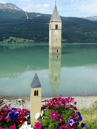 Scenic view of lake by building against sky