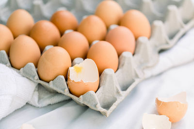 Close up of an egg cracked in a carton