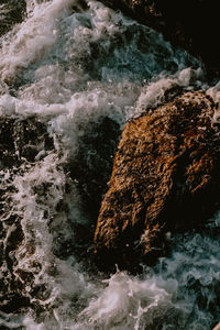 Water flowing through rocks at sea shore