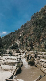 Scenic view of waterfall against sky