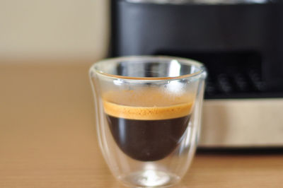 Close-up of coffee in glass on table