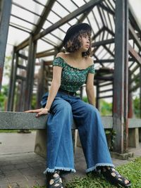 Full length of woman sitting outdoors