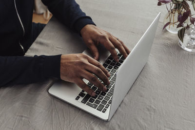 Man's hands on laptop keyboard