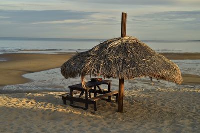 Watermelon picnic under a palm thatched beach umbrella sea of cortez, san felipe, baja, mexico