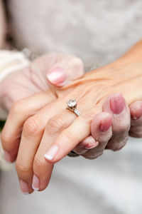 Cropped image of grandmother holding hands of bride