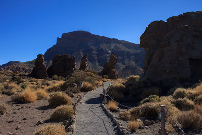 Scenic view of rocky mountains against clear blue sky, tenerife