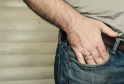 Midsection of man with hand in pocket