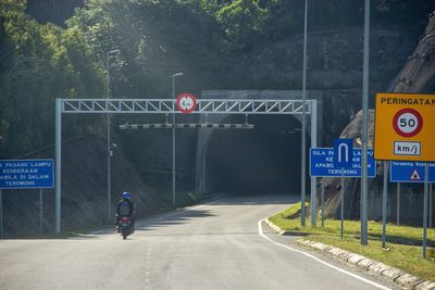 Road sign against trees