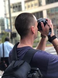 Rear view of man photographing