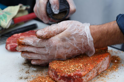 Cropped hand of person preparing food